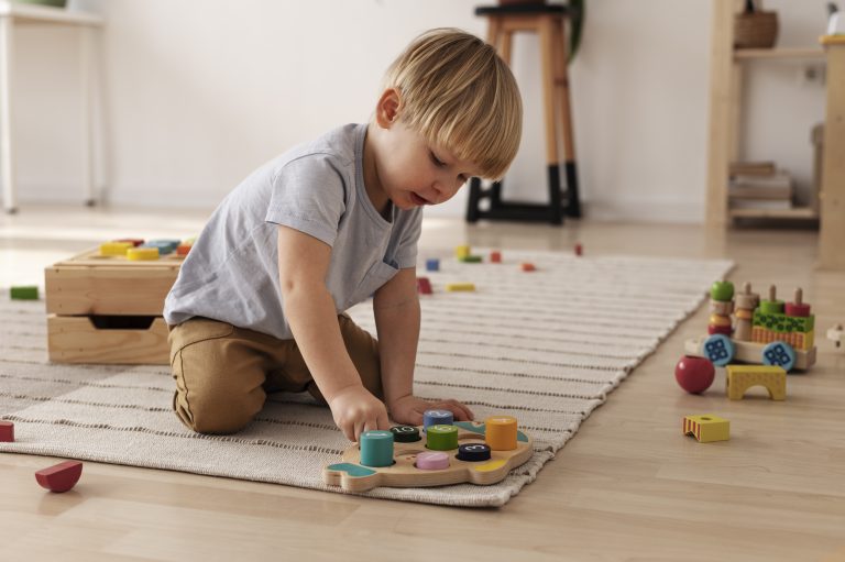 child-playing-with-colorful-toys-full-shot